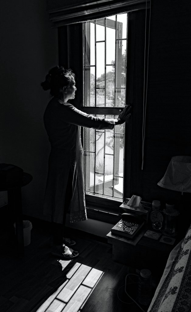 woman standing window