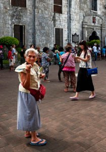 Old Filipina lady selling candles Basilica del Santo Niño